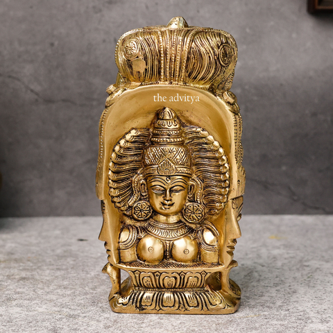 Back design of brass Lord Shiva statue with three faces behind Parvati.