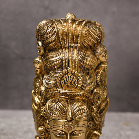 Close-up of brass Lord Shiva statue behind Parvati highlighting fine details.