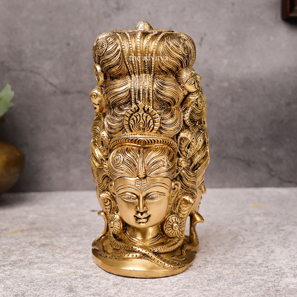 Lord Shiva statue with 3 faces behind Parvati in brass front view.