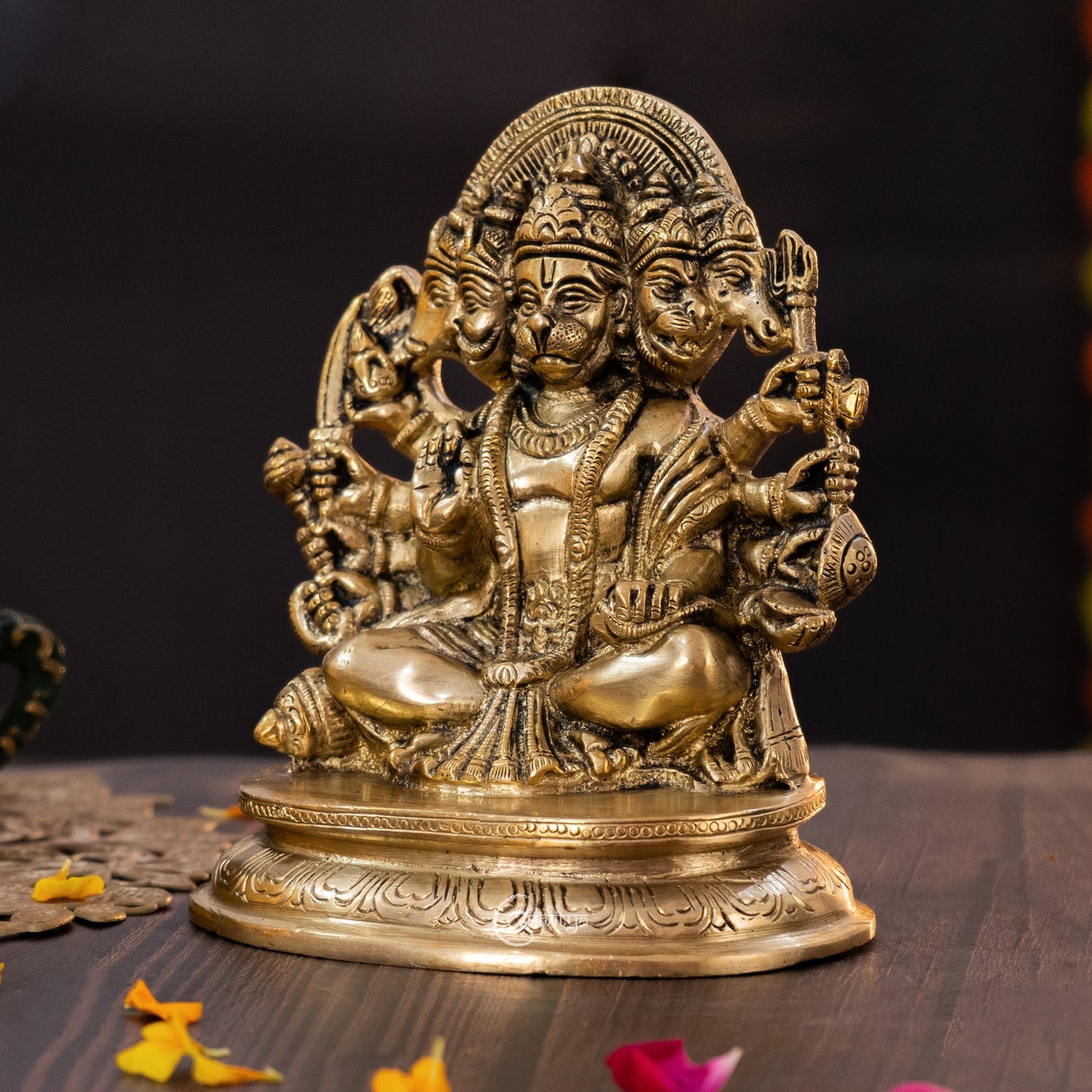 Side angle view of Panchamukhi Hanuman brass idol showing engraved ornaments and traditional posture