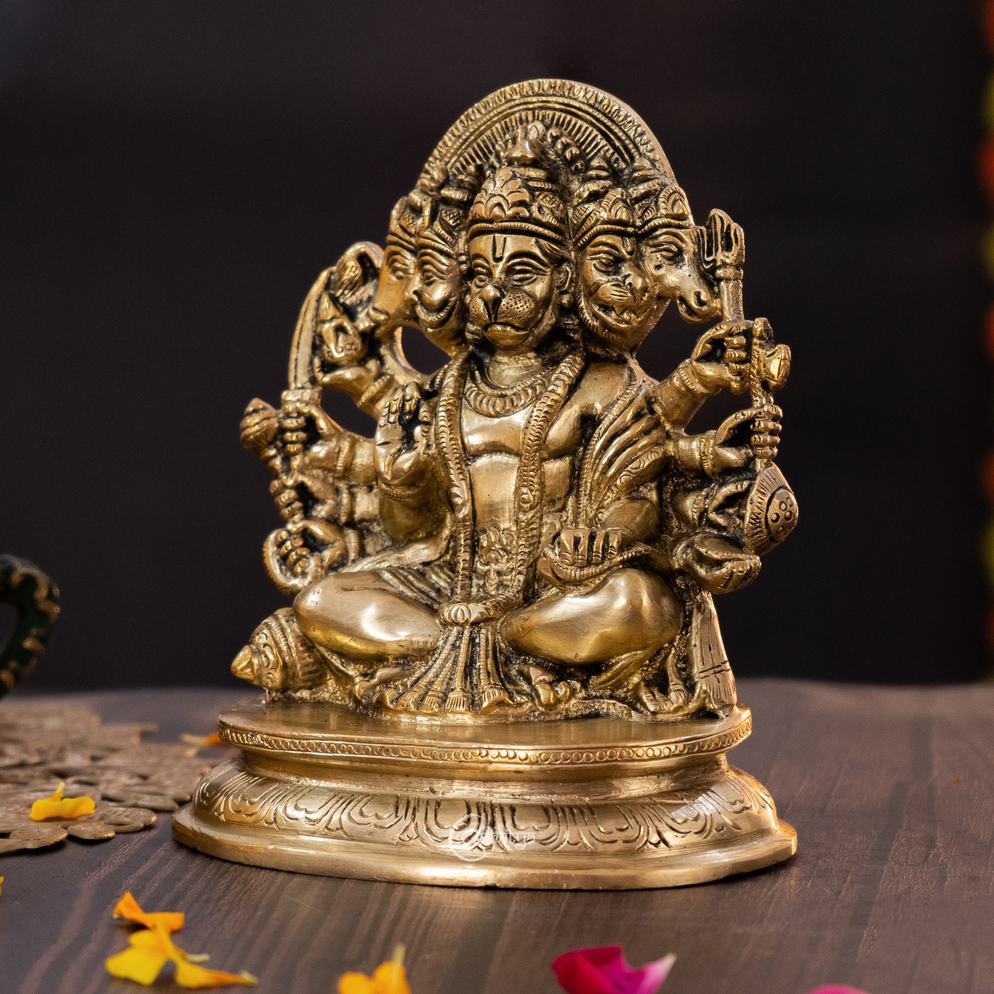 Side angle view of Panchamukhi Hanuman brass idol showing engraved ornaments and traditional posture