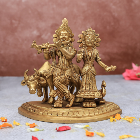 Radha Krishna statue with cow placed in home temple for daily worship and pooja.