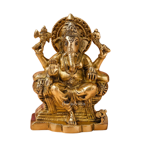 Close-up of Raja Ganesha brass statue highlighting facial detailing and craftsmanship with white background.