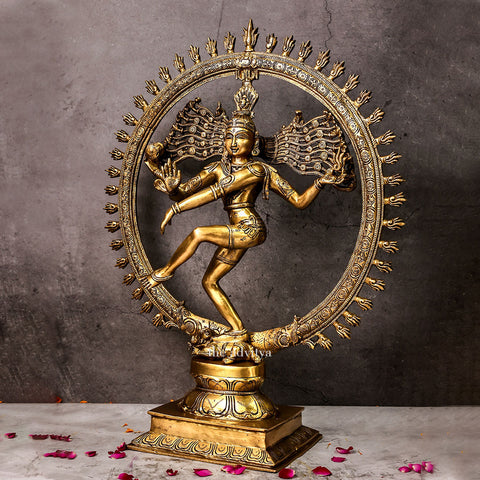 Side angle of a brass Shiva statue depicting Nataraja dance with detailed craftsmanship.