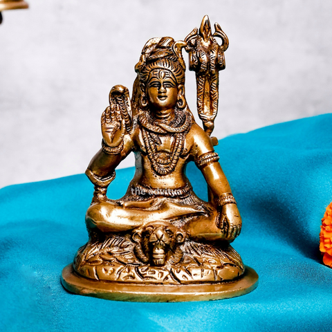 Small brass Shiva statue front view showing detailed posture and blessings hand.