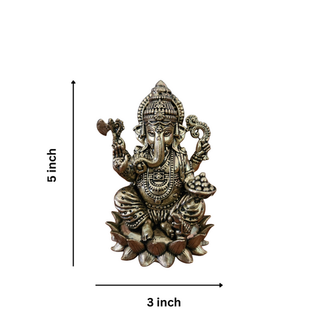 Close-up of super fine brass Ganesha statue highlighting facial expression and ornament detailing.