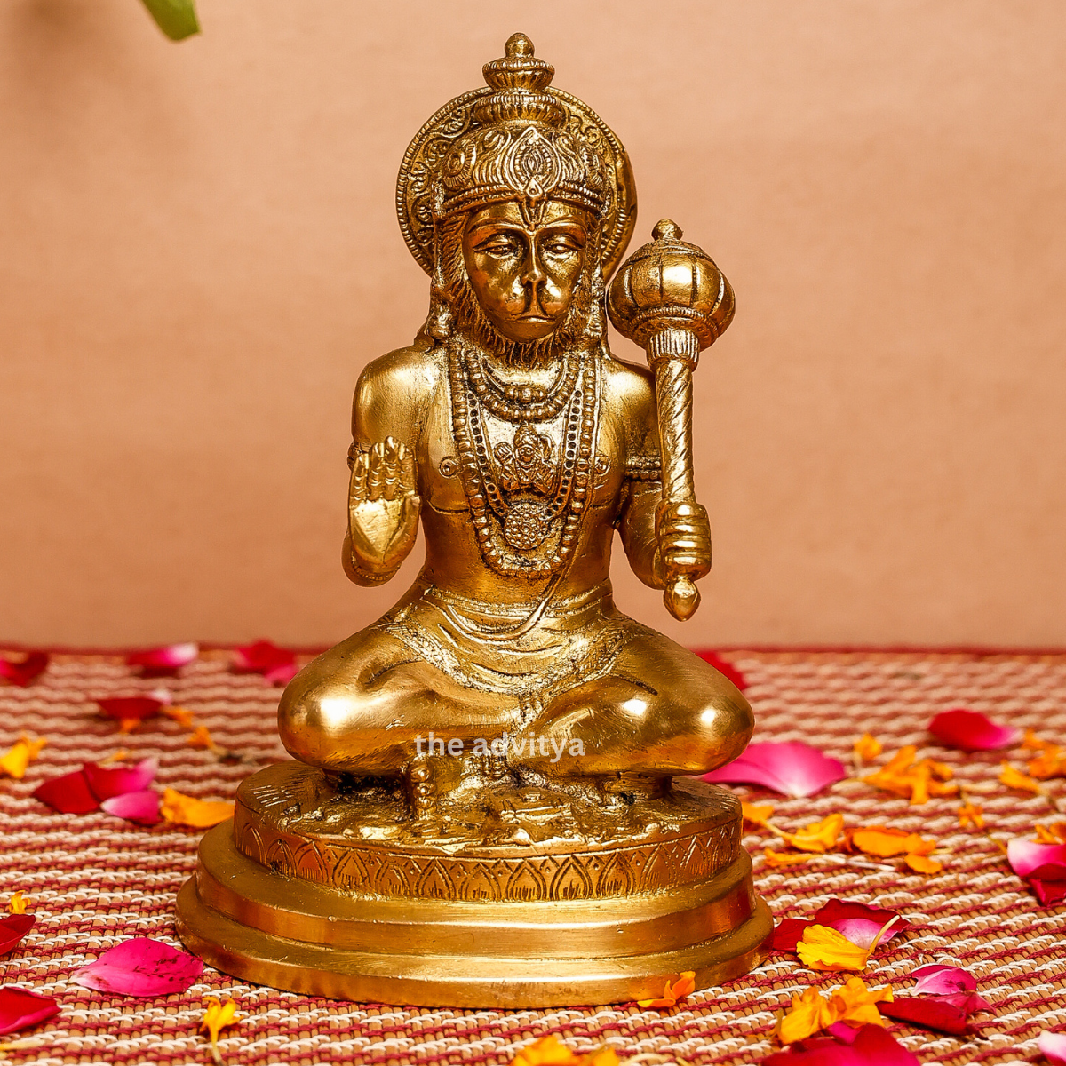 Front view of a handcrafted Brass Hanuman Statue sitting with Gada on a decorative base.