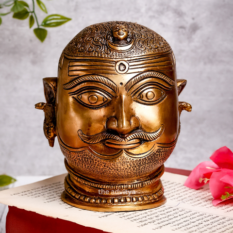 Front view of brass Shiva Head with crescent moon and flowing Ganges details.