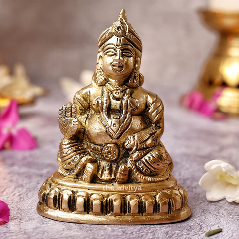 Kubera Statue sitting on a base, front view symbolizing wealth and prosperity.