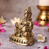 Kubera Statue sitting on a base, left angle with fine craftsmanship.