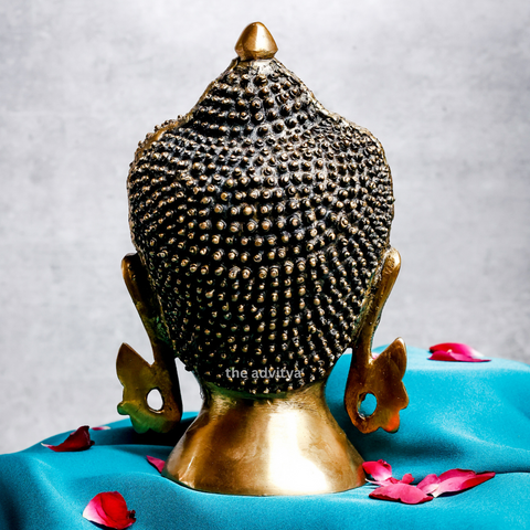 Back view of a large brass Buddha head showing handcrafted detailing