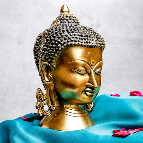 Left angle view of a large brass Buddha head for peaceful living spaces.