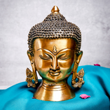 Front view of serene, large brass Buddha head with a peaceful expression.