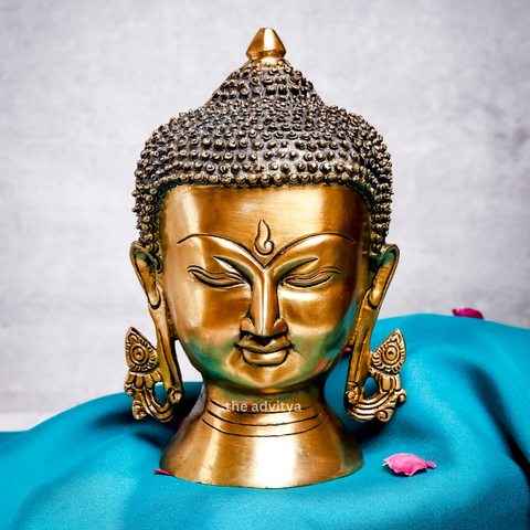 Front view of serene, large brass Buddha head with a peaceful expression.